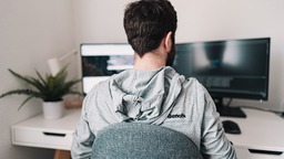 Man working from home on two screens