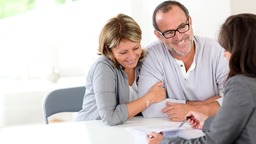 Happy couple meeting with lender